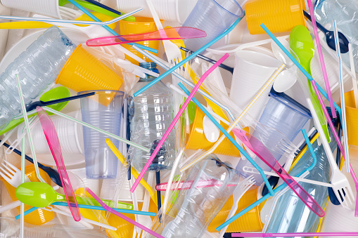 Objetos plásticos desechables de un solo uso como botellas, tazas, tenedores, cucharas y pajitas para beber photo