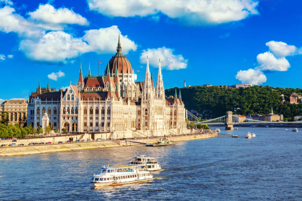 istock Parliament and riverside in Budapest Hungary with sightseeing ships during summer sunny day with blue sky and clouds. Travel and european tourism concept. 1226282955