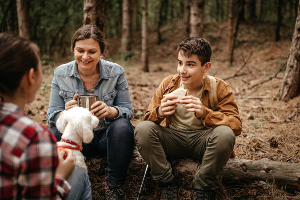 istock Mother with children relaxing at forest 1226285120