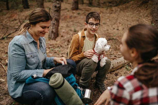 istock Mother with children relaxing at forest 1226285164