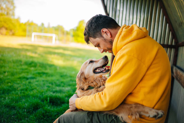 istock Young man having a fun with his dog in the nature 1226286011