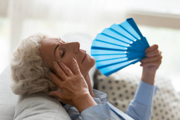 istock Senior woman suffer from hot weather using hand fan 1226286138