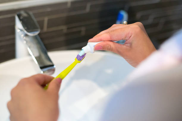 istock Woman washing teeth in the bathroom 1226288879