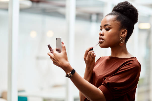 istock Adding a touch of lipstick to complete her boss look 1226290705