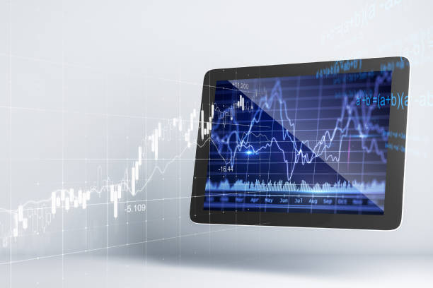 istock Close up of tablet with stock chart hologram. 1226290818