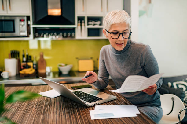 istock Senior woman doing paperwork at home. 1226295222
