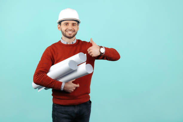 istock Happy young bearded engineer or constructor man in casual outfit show bad gesture over cyan background. 1226296306