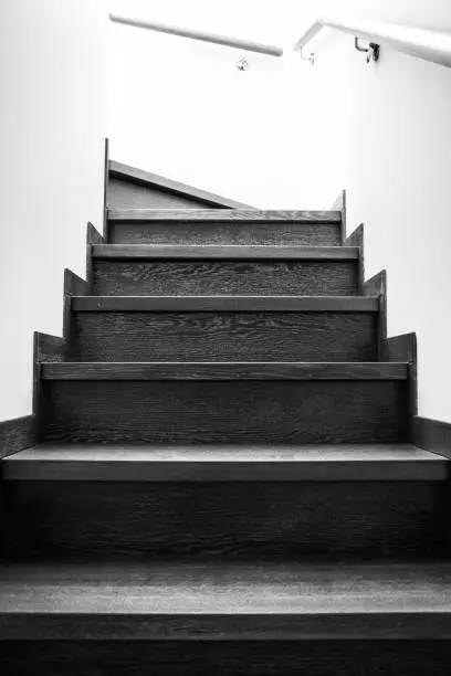 Photo of Wooden stairs in the house. Monochrome stairs up. Wooden interior elements.