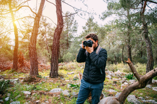 istock Man Taking Pictures in the Forest 1226297022