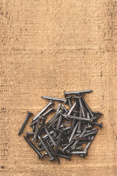 istock Black nails on wooden table. Copy space. 1226299007