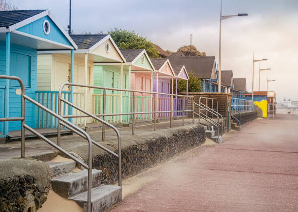 Pastel coloured beach huts Pretty pastel coloured beach houses near the sea in Clacton, England. clacton on sea stock pictures, royalty-free photos & images