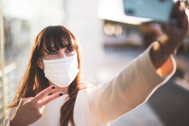 istock Woman smiling behind the protective mask 1226300002