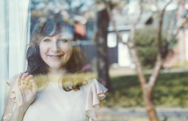 istock Girl looking outside with hope during COVID-19 Lockdown spring time Oxford eye on camera 1226301704