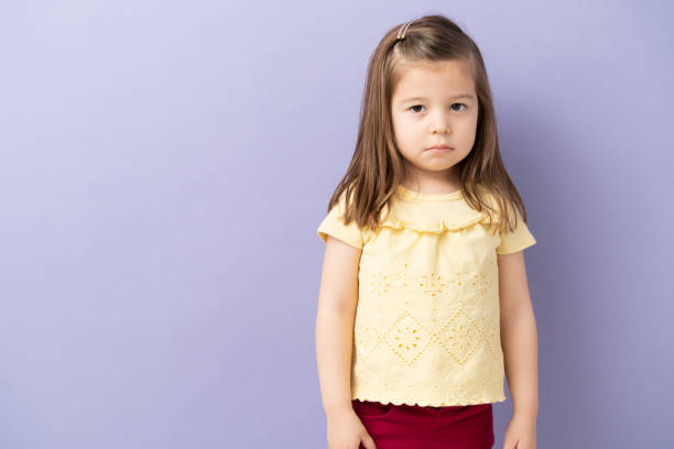 Little girl with sad face looking at camera. Space for copy.