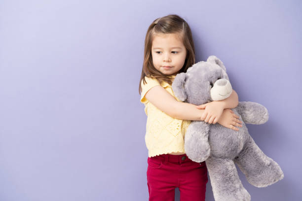 istock Cute little girl hugging teddy bear 1226304110