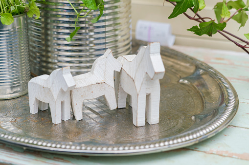Small Dalecarlian or Dala horses on a metal dish in Sweden, Stockholm County, Upplands Väsby