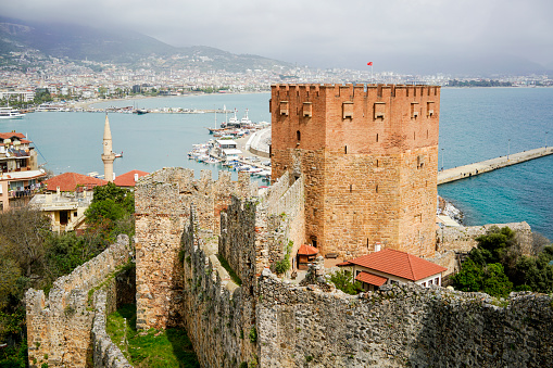 Kızıl Kule (Red octagonal Tower) with Alanya bay in the background in Turkey, Antalya, Alanya