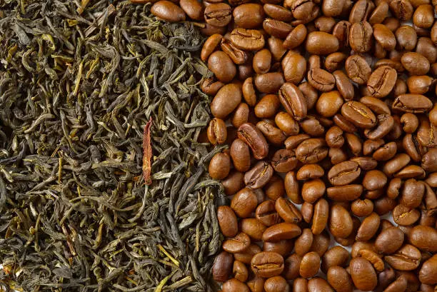 Photo of Dry leaves of green tea and fine Roasted coffee beans, top view closeup. Coffee or Green tea concept.