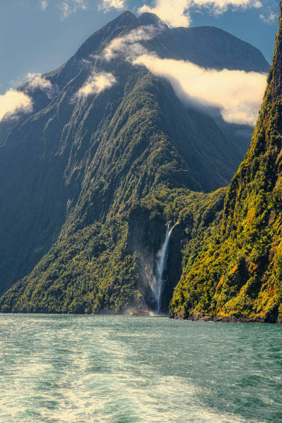 Waterfall in Milford Sound's fiord land in the south island of New Zealand. stock photo