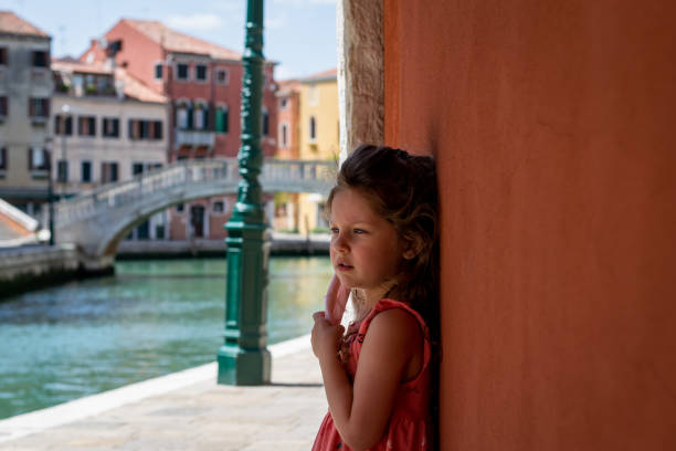 side portrait of a little girl wearing a home made surgical mask