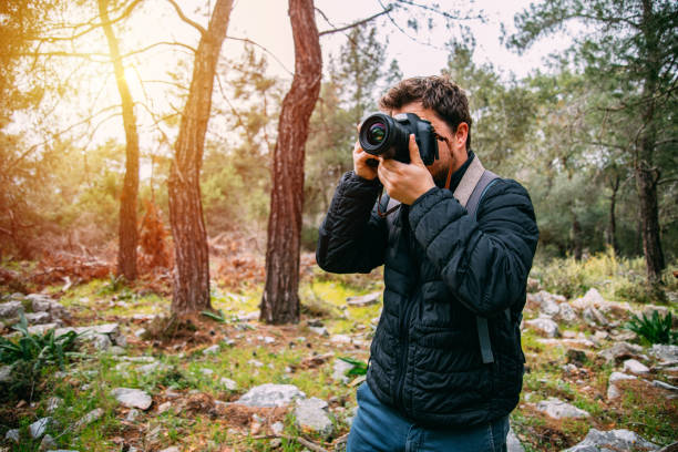 istock Man Taking Pictures in the Forest 1226315265
