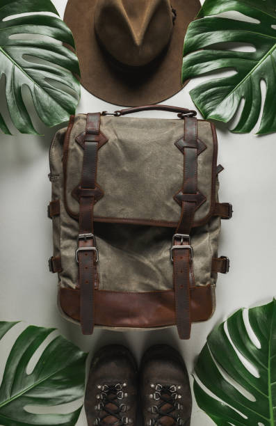 istock Explorer backpack, hat and shoes on tropical abstract background 1226317948