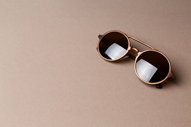 istock Brown classy sunglasses on minimal paper background 1226317950