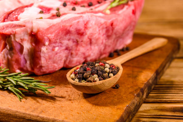 istock Raw pork ribs with spices and rosemary on a cutting board 1226321393