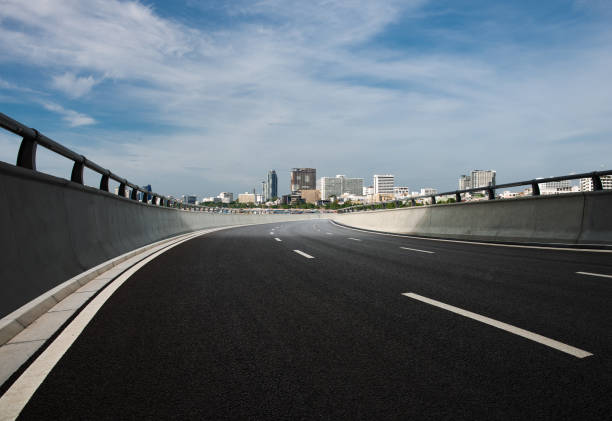istock Clear blue sky and white clouds in the background, highway overpass curved approach bridge 1226321994