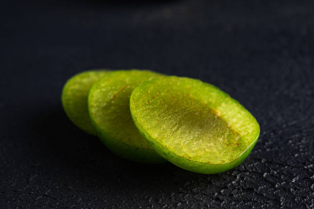 green sour plum. Greengage on dark background stock photo