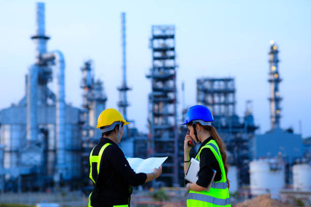 Smart two female engineer discussion together at refinery industry plant at industry factory center area. Engineering Concept Smart two female engineer discussion together at refinery industry plant at industry factory center area. Engineering Concept refinery photos stock pictures, royalty-free photos & images