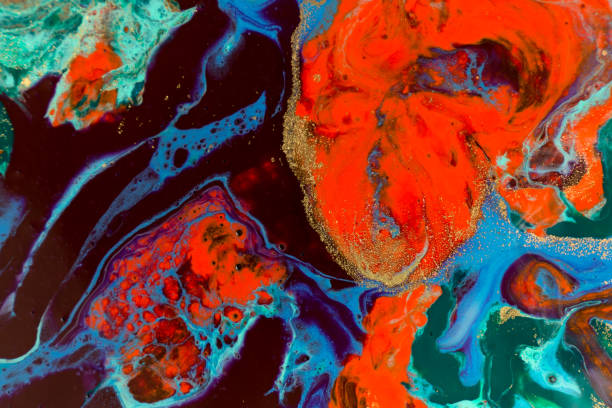 istock Mixed colorful inks background. Abstract paint texture with golden glitter. 1226324272