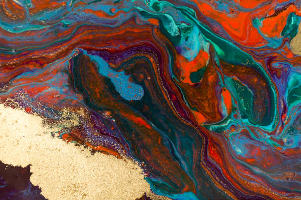 istock Mixed colorful inks background. Abstract paint texture with golden glitter. 1226324299