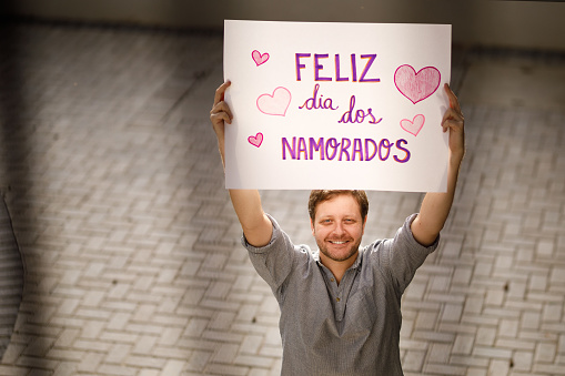 Man holding a valentine's day poster.