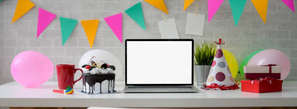Online Birthday celebration concept with blank screen laptop, cake and decorations Online Birthday celebration concept with blank screen laptop, cake and decorations on white table cake models stock pictures, royalty-free photos & images