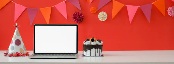 Online Birthday celebration concept with blank screen laptop, cake and copy space