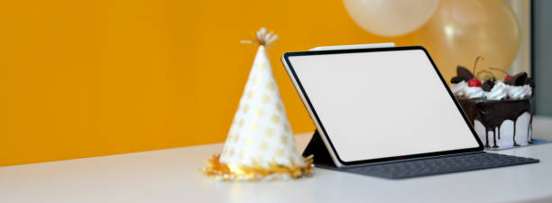 istock Online cerebration concept with blank screen tablet and party hat on white table 1226325797