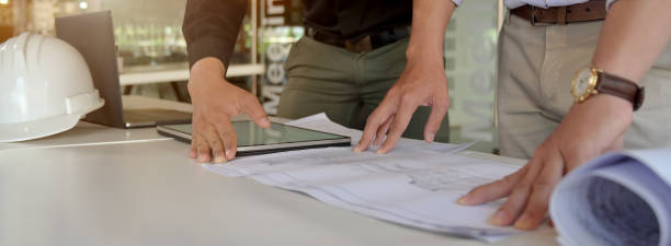 istock Cropped shot of two engineers working together with mock-up tablet and paperwork 1226325809