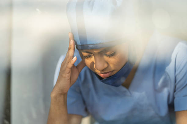 istock Female medical professional looking out window 1226327419