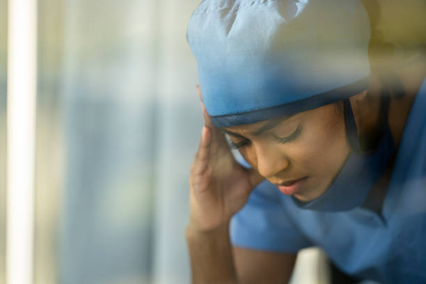 istock Female medical professional looking out window 1226327425