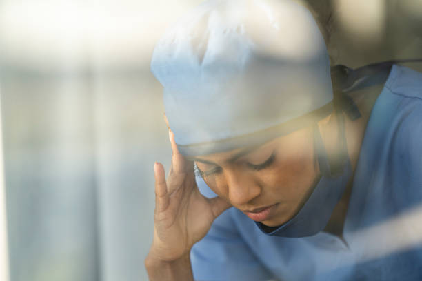 istock Female medical professional looking out window 1226327430