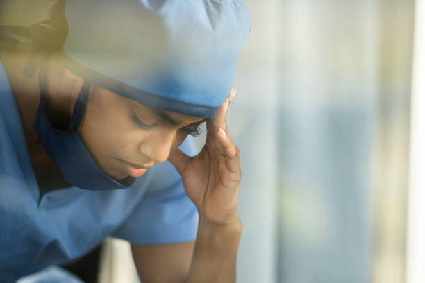 istock Female medical professional looking out window 1226327431