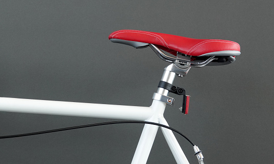 This is a red bike saddle seat of modern bicycle.