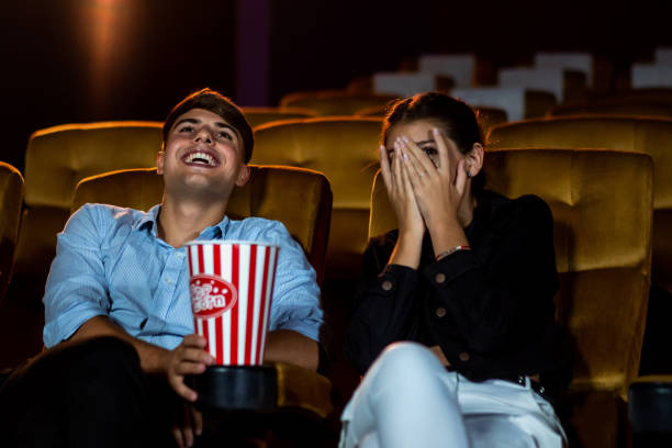 a couple of caucasian watch a movie in the cinema - audience surprise movie theater shock imagens e fotografias de stock