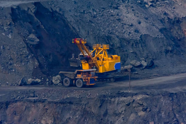 istock Heavy excavator loading huge dump truck with iron ore in the quarry 1226328696