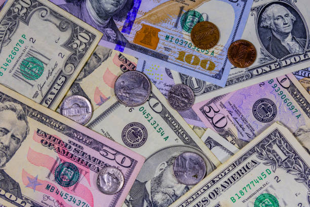 istock Different american cent coins over the dollar banknotes 1226330564