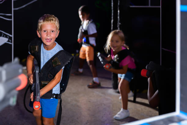 istock Portrait of glad tweenager boy with laser gun 1226332641