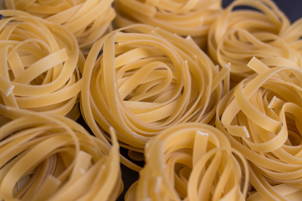 istock tagliatelle noodles on black background - closeup 1226335794