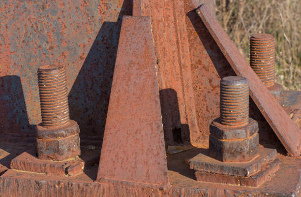 Fragment of a rusty iron construction with bolts and nuts.
