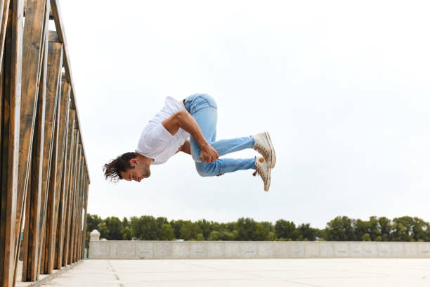 istock young man learning to do somersault outdoors 1226338665